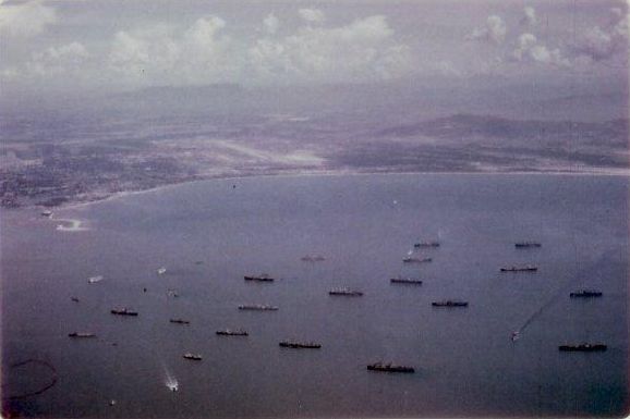 Ships in Da Nang harbor. Da Nang Main airfield in the background