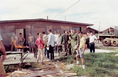 Get together behind the Officers Club. Right center, looking at the camera, is Don Long and Bob Goodspeed. Just to the right with white shirt is Ned Wilson