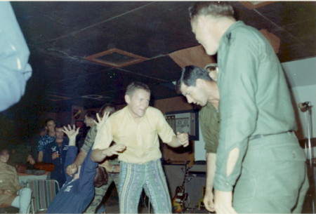 Charlie Finch telling war story, Bobby Goodspeed looking down, 1969