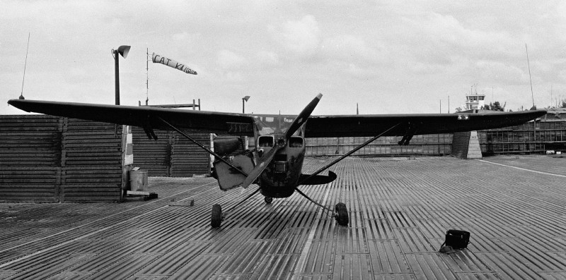 a hard landing that bent the left landing gear and wing tip looking East on the 220th ramp at Phu Bai