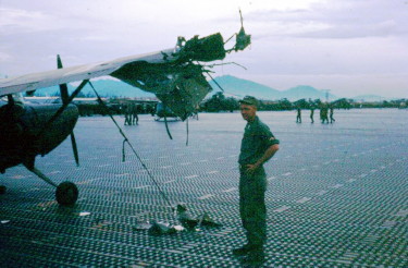 Unidentified crew chief at Marble Mountain airport, 1966, following a mortar attack Unidentified crew chief at Marble Mountain airport, 1966, following a mortar attack